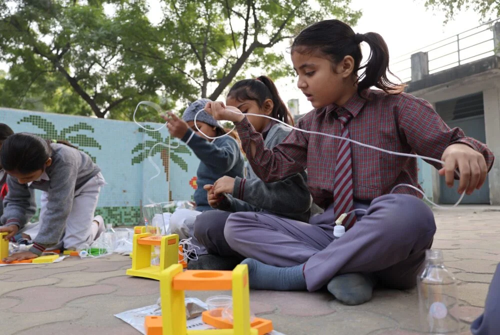 students-doing-activity-with-pipe